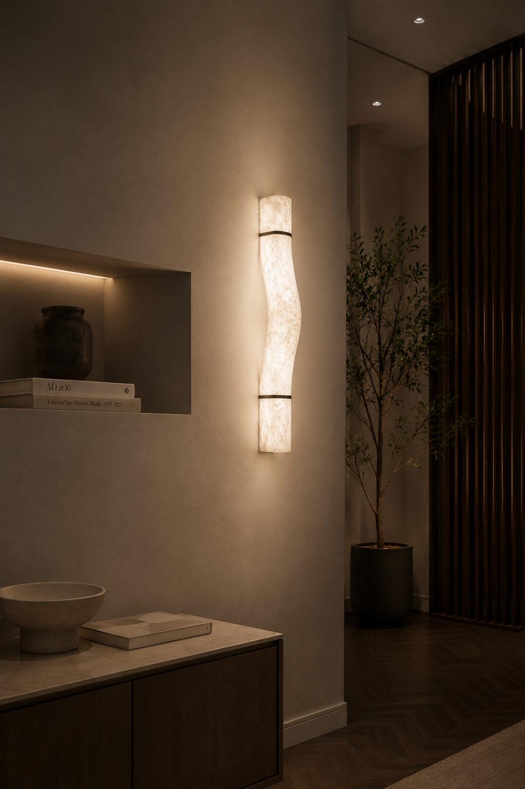 Natural alabaster wall sconce LIBRA with warm glow and visible veining mounted on textured beige wall