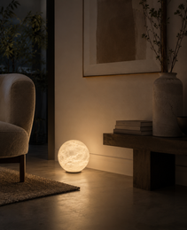 Marsa Ground alabaster table lamp on concrete floor with warm diffused light in minimalist living room