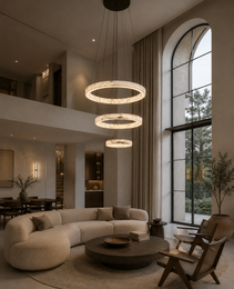 Three-tier alabaster pendant light with creamy white veined rings in high-ceiling living room