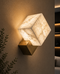 Close-up Petra alabaster wall light showing creamy white veining and brushed brass cube base detail