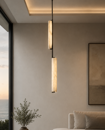 Close-up of Staria Ceil alabaster pendant showing creamy off-white veining, warm glow, and staggered cylinder design
