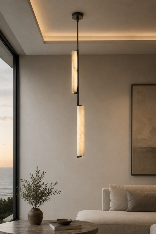 Close-up of Staria Ceil alabaster pendant showing creamy off-white veining, warm glow, and staggered cylinder design