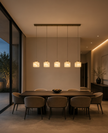 Linear five-light alabaster pendant chandelier with matte bronze canopy over dark wood dining table