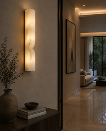 SINUA curved alabaster wall sconce with warm glow in minimalist living room