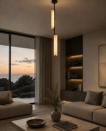 Staria Ceil vertical pendant light with stacked natural alabaster cylinders and matte black metal fixture in modern living room
