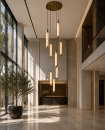Seven-tier vertical alabaster chandelier with brass canopy in modern double-height lobby