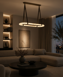 Modern linear pendant light with two oval alabaster diffusers and matte brass mount in dusk living room